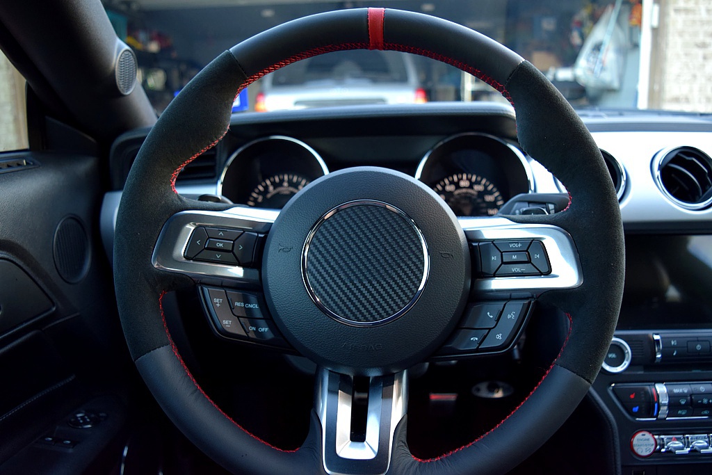 Ford Mustang steering wheel with increased girth and thumb-grips and a red racing stripe